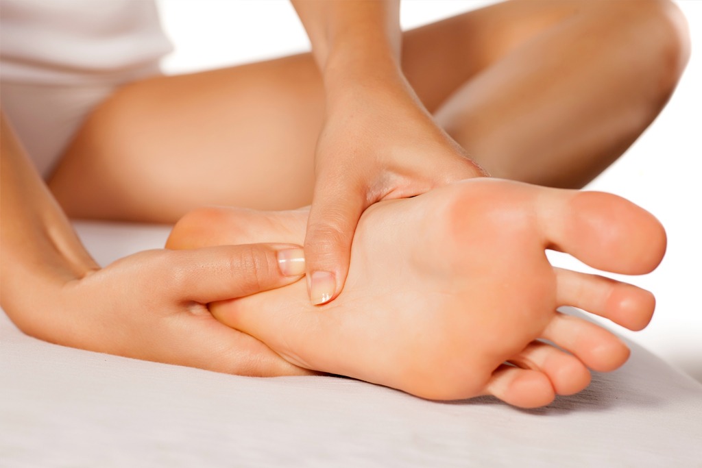 woman massaging her tired feet